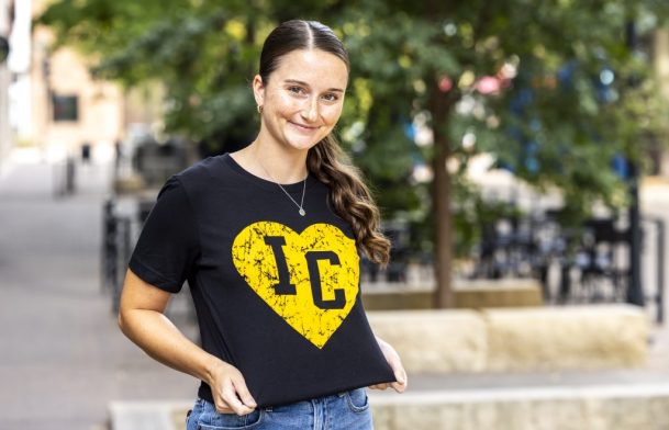 Kylee Walker wears a black shirt with the yellow IC heart logo for a Shop Think Iowa City merchandise photo shoot, Friday, Sept. 13, 2024, in Iowa City, Iowa. MANDATORY CREDIT: Joseph Cress/Think Iowa City