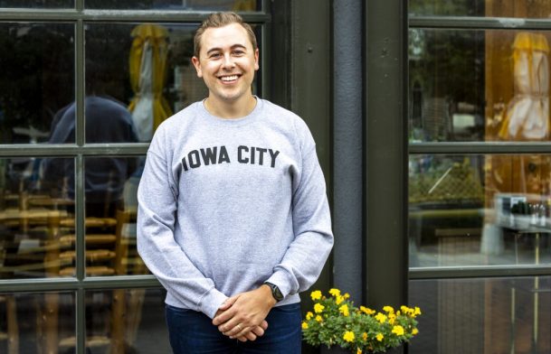 Austin Korns wears a gray Iowa City crew neck sweatshirt for a Shop Think Iowa City merchandise photo shoot, Friday, Sept. 13, 2024, in Iowa City, Iowa. MANDATORY CREDIT: Joseph Cress/Think Iowa City